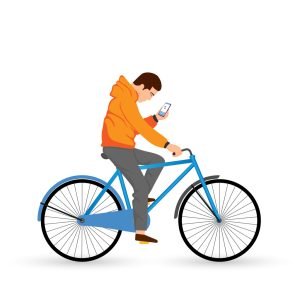 Young man uses the smartphone and rides his bike